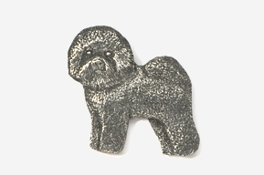 A silver dog shaped pin on a white background.