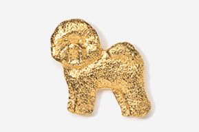 A gold dog shaped pin with a white background