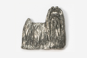 A silver dog is standing up against the wall.