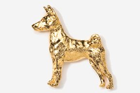 A gold dog is standing up against the wall.