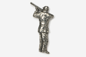 A silver pin of a man holding a gun.