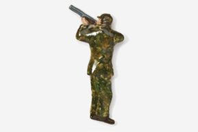 A toy soldier holding a rifle in his hand.