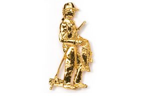 A gold colored metal figurine of two men.