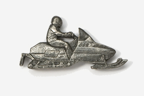 A silver snowmobile with a man on it.