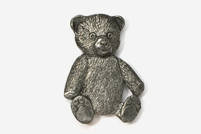 A silver bear sitting on top of a white table.