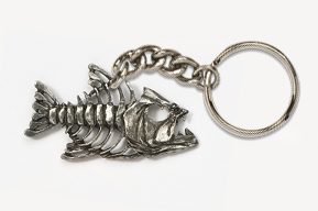 A silver fish skeleton keychain on top of a white surface.