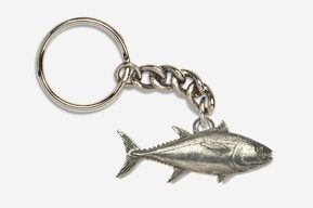 A silver keychain with a fish on it.