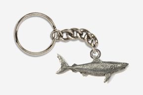 A silver key chain with a shark on it.