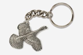 A silver key chain with a bird flying.