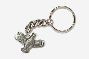 A silver key chain with a bird on it.