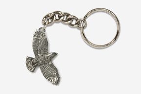 A silver key chain with a bird on it.