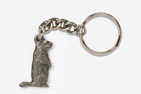 A metal keychain with a bear on it