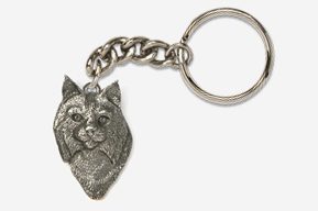 A silver key chain with a dog 's head on it.