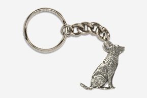 A silver key chain with a dog sitting on it.