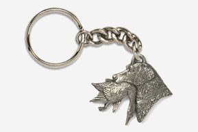 A silver key chain with a wolf head on it.