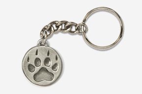 A silver key chain with a paw print on it.