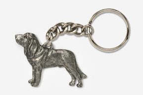 A metal keychain with a dog on it.