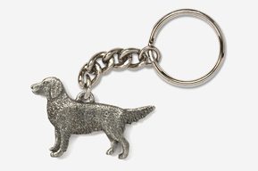 A silver key chain with a dog on it.