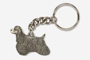 A silver key chain with a dog on it.