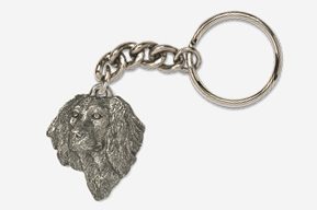 A silver key chain with a dog 's head on it.