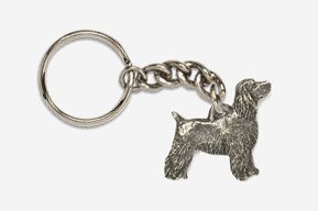 A silver key chain with a dog on it.