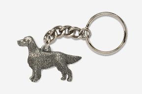 A metal key chain with a dog on it.