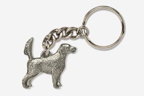 A silver key chain with a dog on it.