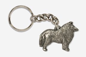 A metal keychain with a dog on it.