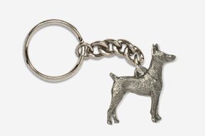 A silver key chain with a dog on it.