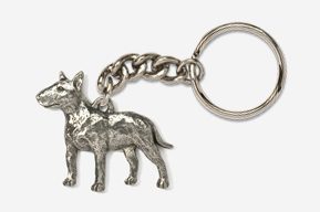 A silver key chain with a dog on it.