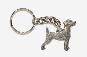 A dog is standing on the chain of a keychain.