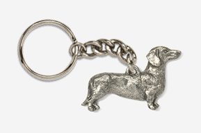 A silver dachshund dog keychain is shown.