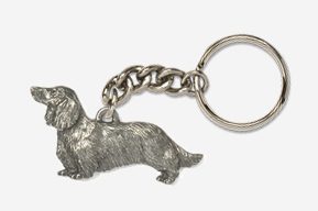 A silver dachshund dog keychain is shown.