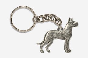 A silver key chain with a dog on it.