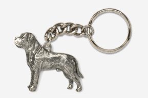 A silver key chain with a dog on it.