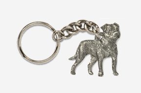 A silver key chain with two dogs on it.