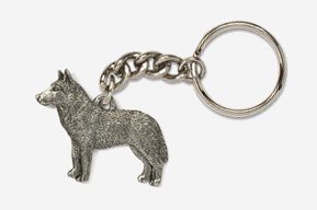 A metal keychain with a dog on it.