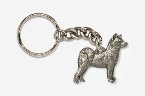 A silver key chain with a dog on it.