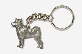 A silver key chain with a dog on it.