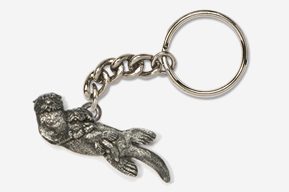 A silver key chain with a dog on it.