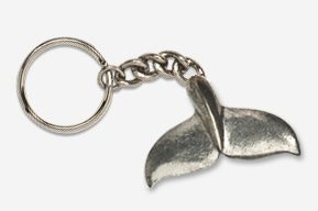 A silver key chain with a metal whale 's tail.