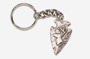 A silver arrowhead keychain with a bird on it.