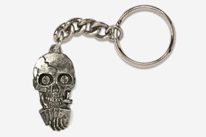 A keychain with a skull and hand on it.