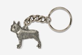 A silver key chain with a dog on it.