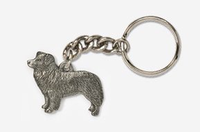 A silver key chain with a dog on it.