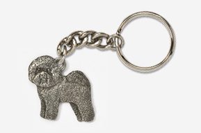 A silver key chain with a dog on it.