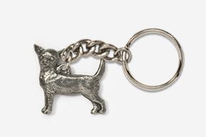 A silver key chain with a dog on it.