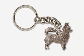 A silver key chain with a dog on it.