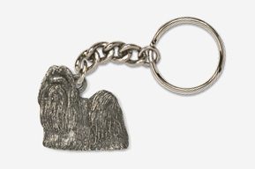 A silver key chain with a dog on it.