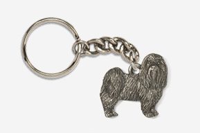 A metal keychain with a picture of a dog.